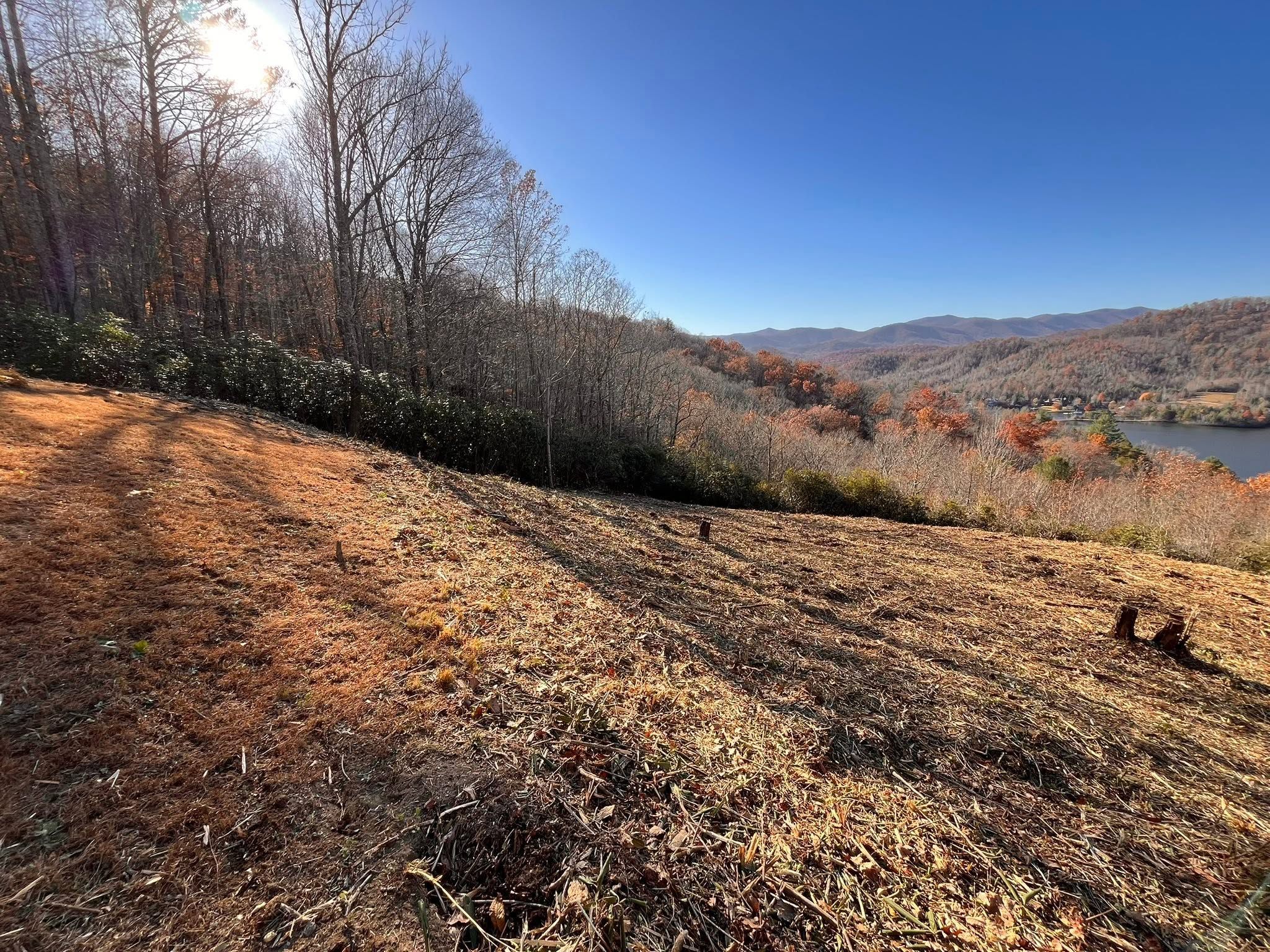 Cleared mountain lot overlooking lake and ridgelines