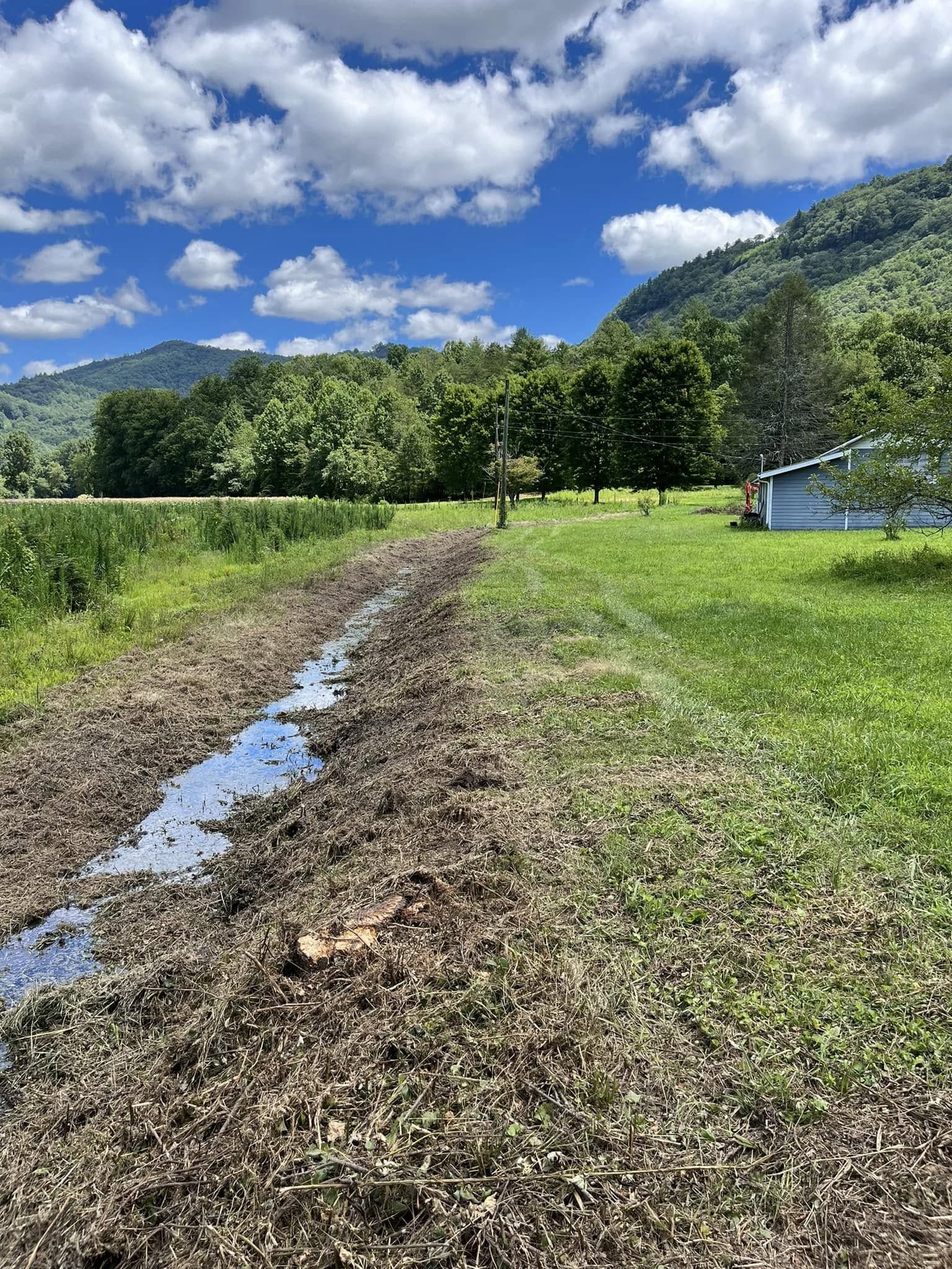 Drainage channel carrying water through mountain terrain