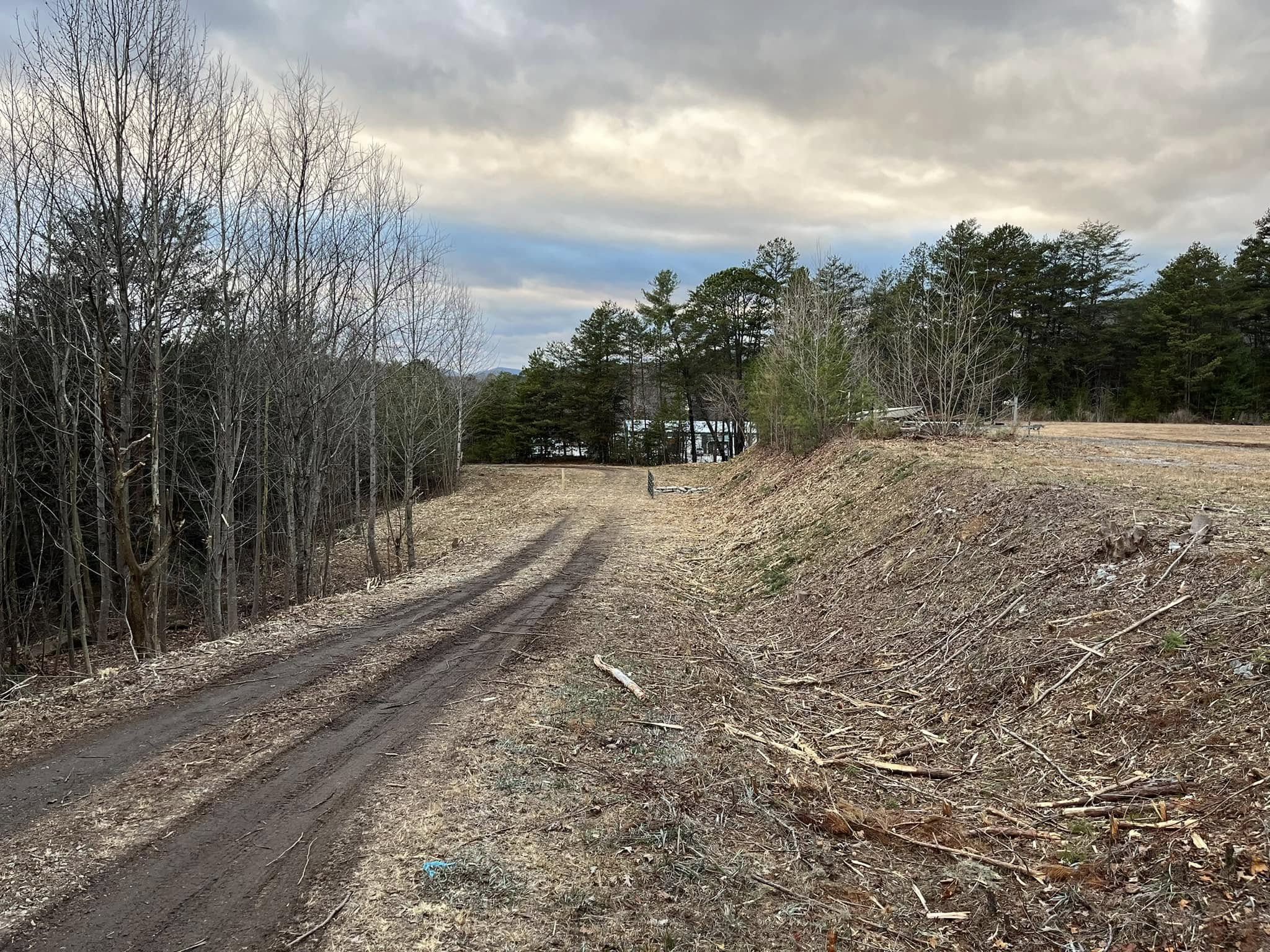 Graded access path cut across a steep cleared hillside